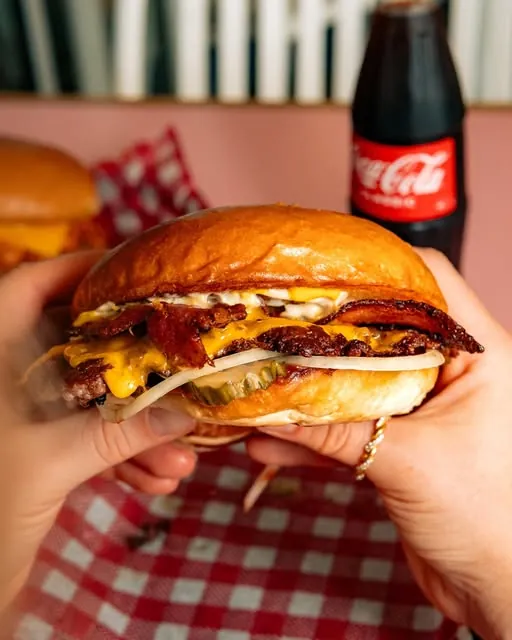 Double bacon cheeseburger held up